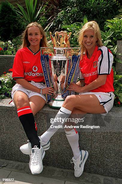 Models dressed in the strips of Manchester United and Arsenal with the new FA Barclaycard Premiership Trophy at the Royal Lancaster Hotel, London....