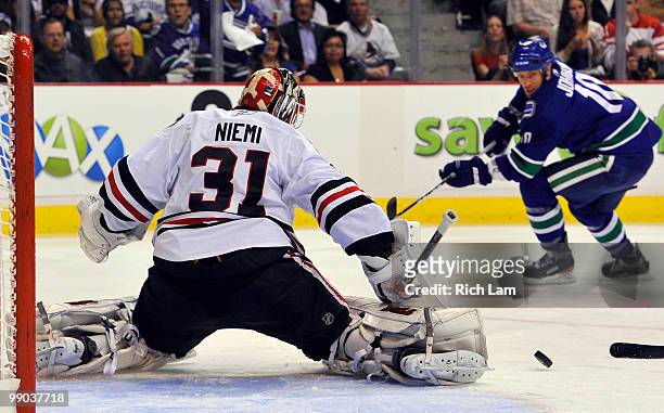 Goalie Antti Niemi the Chicago Blackhawks makes a pad save off the shot of Ryan Johnson of the Vancouver Canucks during the first period in Game Six...