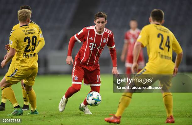 Bayern Munich's Sebastian Rudy vying for the ball against Grossaspach's Jannes Hoffmann and Yannick Thermann during the Bayern Munich vs Sonnenhof...
