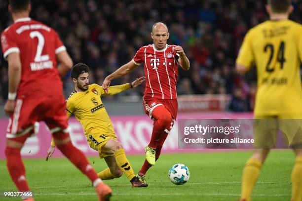 Bayern Munich's Arjen Robben and Grossaspach's Taxiarchis Fountas vying for the ball during the Bayern Munich vs Sonnenhof Grossaspach soccer...