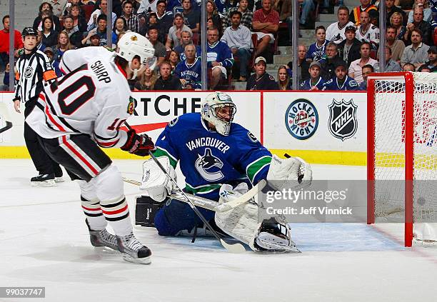 Goalie Roberto Luongo of the Vancouver Canucks makes a save off a shot from Patrick Sharp of the Chicago Blackhawks in Game 6 of the Western...