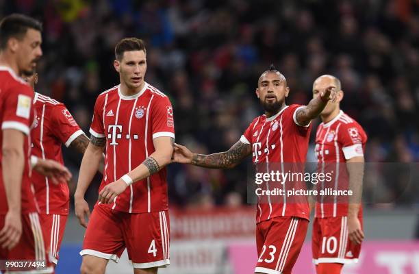 Bayern Munich's Niklas Suele and Arturo Vidal speaking with each other during the Bayern Munich vs Sonnenhof Grossaspach soccer friendly match in the...