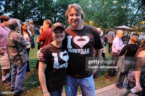 Connie Harrington and Jon Mabe display their t-shirts, which are dedicated to raising money for flood victims, at the 12th Annual GRAMMY Block Party...