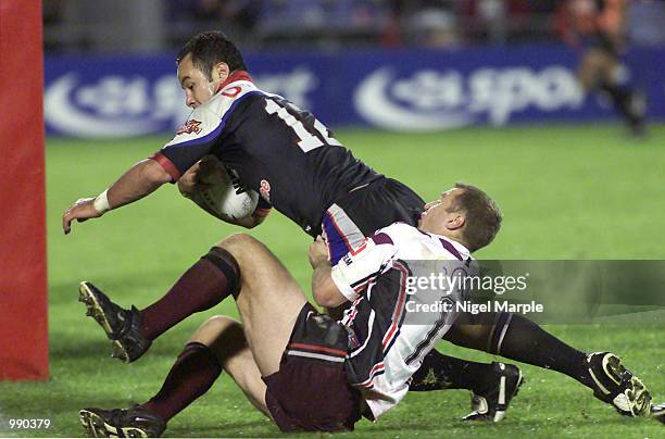 Monty Betham of the Warriors goes over for a try while tackled by Brendon Reeves of the Norhtern Eagles during the round 15 NRL match between the New...
