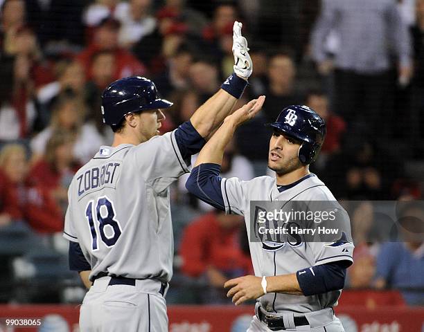 Sean Rodriguez of the Tampa Bay Rays celebrates his run with Ben Zobrist for a 1-0 lead over the Los Angeles Angels during the second inning at...