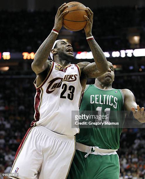 LeBron James of the Cleveland Cavaliers tries to get a shot off around Glen Davis of the Boston Celtics during Game Five of the Eastern Conference...