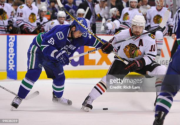 Shane O'Brien of the Vancouver Canucks hits Patrick Sharp of the Chicago Blackhawks with a high stick during the second period in Game Six of the...