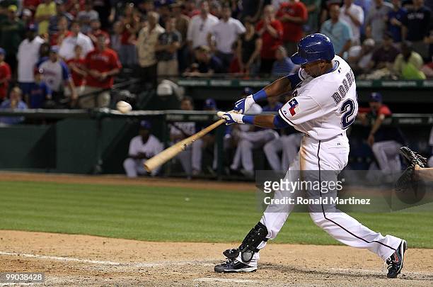 Julio Borbon of the Texas Rangers drives in a run on a single against the Oakland Athletics in the 11th inning on May 11, 2010 at Rangers Ballpark in...