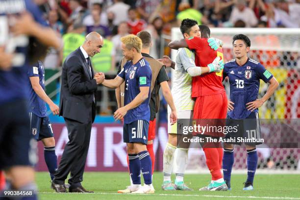 Yuto Nagatomo and Eiji Kawashima of Japan are consoled by head coach Roberto Martinez and Romelu Lukaku of Belgium after the 2018 FIFA World Cup...