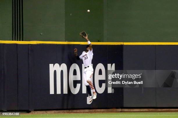 Keon Broxton of the Milwaukee Brewers leaps to catch a fly ball in the seventh inning against the Minnesota Twins at Miller Park on July 2, 2018 in...