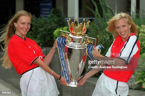 Models dressed in the strips of Manchester Unired and Arsenal with the new FA Barclaycard Premiership Trophy at the Royal Lancaster Hotel, London....