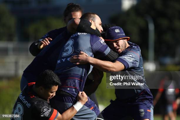 Simon Mannering of the Warriors is tackled during a New Zealand Warriors NRL training session at Mount Smart Stadium on July 3, 2018 in Auckland, New...