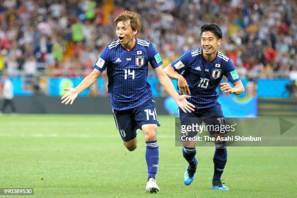 Takashi Inui of Japan celebrates scoring his side's second goal with his team mate Shinji Kagawa during the 2018 FIFA World Cup Russia Round of 16...