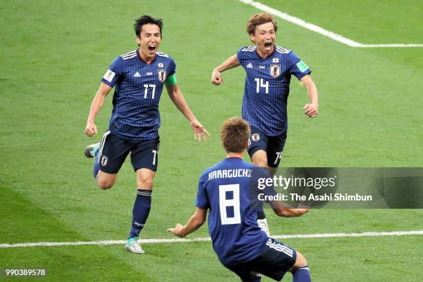 Takashi Inui of Japan celebrates scoring his side's second goal with his team mates Makoto Hasebe and Genki Haraguchi during the 2018 FIFA World Cup...