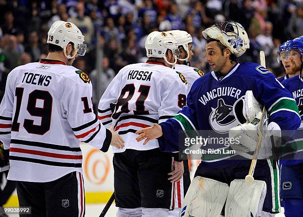 Goalie Roberto Luongo of the Vancouver Canucks shakes hands with Jonathan Toews of the Chicago Blackhawks after the Blackhawks defeated the Canucks...