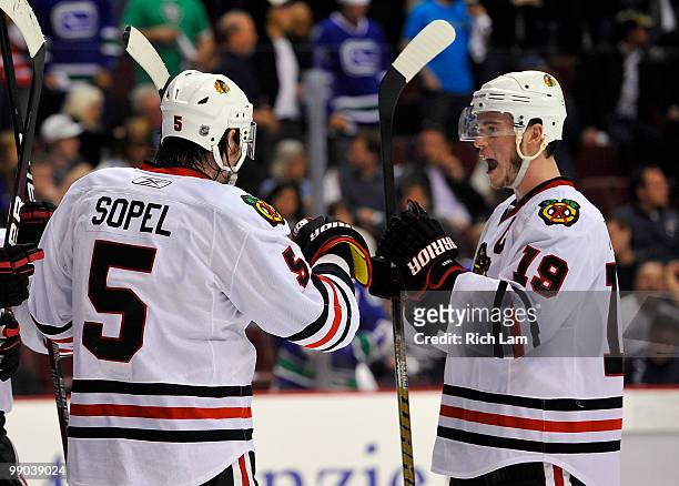 Jonathan Toews and Brent Sopel of the Chicago Blackhawks celebrate after defeating the Vancouver Canucks in Game Six of the Western Conference...