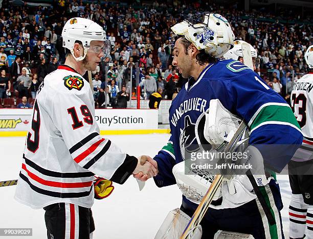 Roberto Luongo of the Vancouver Canucks shakes hands with Jonathan Toews of the Chicago Blackhawks in Game 6 of the Western Conference Semifinals...
