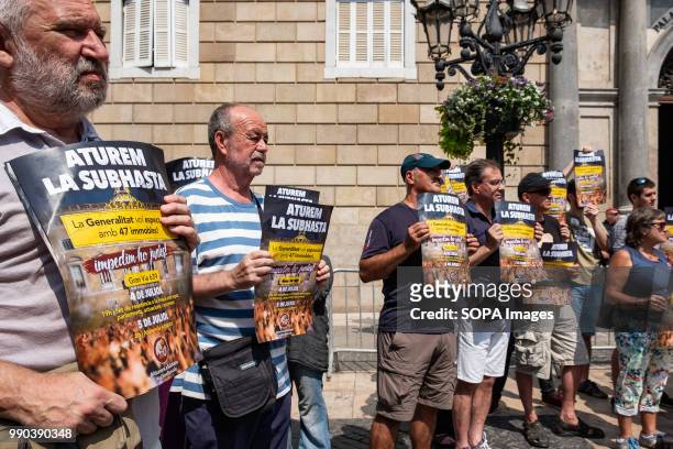 Group of pro housing activists seen showing posters for the July 5 call. The Generalitat of Catalonia intends to auction this week 47 properties from...
