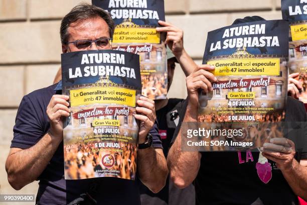 Group of pro housing activists seen showing posters for the July 5 call. The Generalitat of Catalonia intends to auction this week 47 properties from...