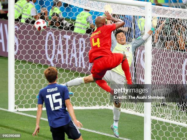 Eiji Kawashima of Japan and Vincent Kompany of Belgium compete for the ball during the 2018 FIFA World Cup Russia Round of 16 match between Belgium...