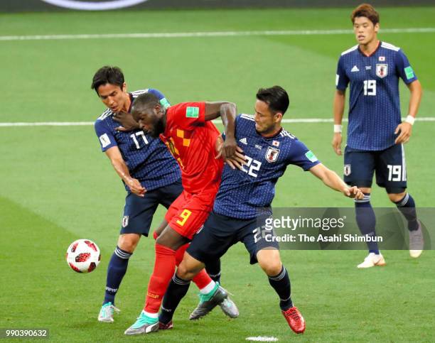 Romelu Lukaku of Belgium controls the ball under pressure of Maya Yoshida and Makoto Hasebe of Japan during the 2018 FIFA World Cup Russia Round of...
