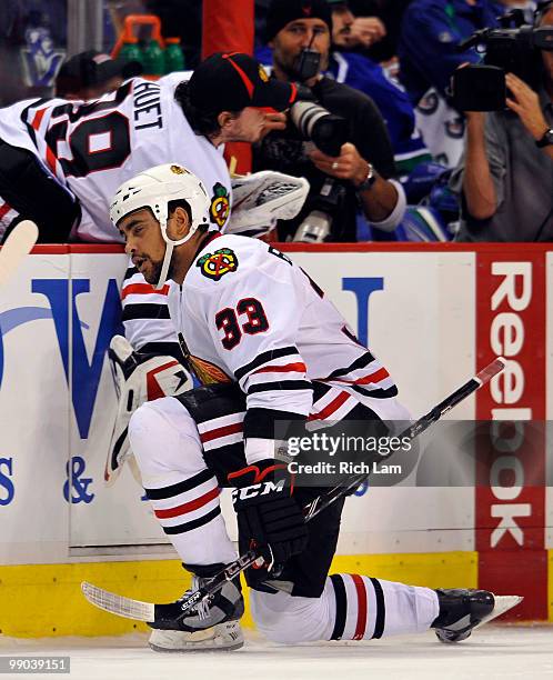 Dustin Byfuglien of the Chicago Blackhawks celebrates with teammate Cristobal Huet after scoring against the Vancouver Canucks during the third...