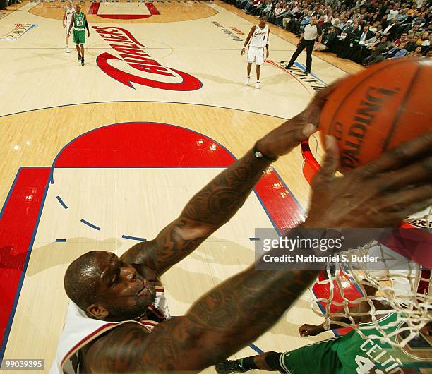 Shaquille O'Neal of the Cleveland Cavaliers dunks against Kendrick Perkins of the Boston Celtics in Game Five of the Eastern Conference Semifinals...