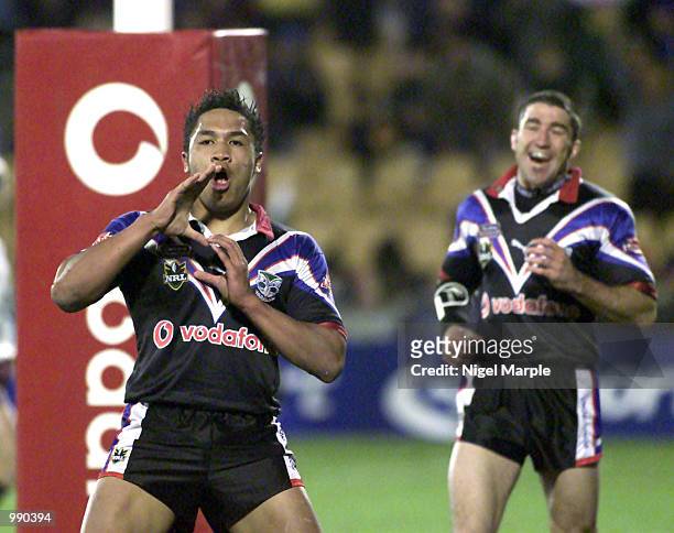 Wairangi Koopu of the Warriors celebrates scoring a try watched by Nathan Wood during the round 15 NRL match between the New Zealand Warriors and the...
