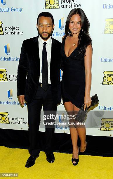 Singer John Legend and model Christine Teigen pose for photos at the 7th Annual Project Sunshine Benefit at The Waldorf Astoria on May 11, 2010 in...