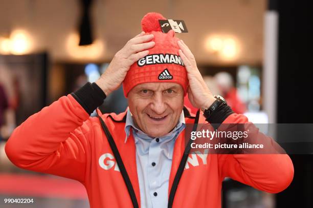President Alfons Hoermann puts on the official hat for the Winter Olympic Games Pyeonchang in Munich, Germany, 11 January 2018. Photo: Tobias Hase/dpa