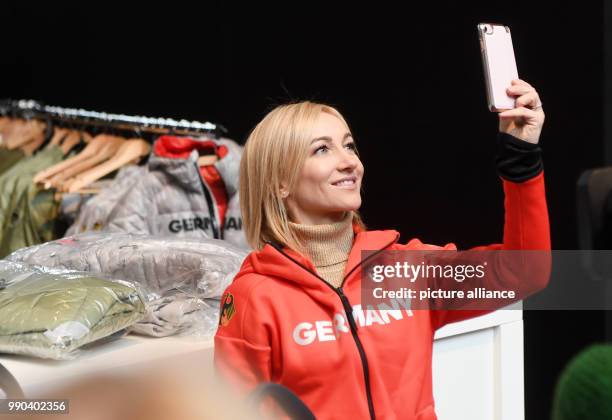 Figure skater Aljona Savchenko picks up her official outfit for the Winter Olympic Games Pyeongchang and takes a selfie in Munich, Germany, 11...