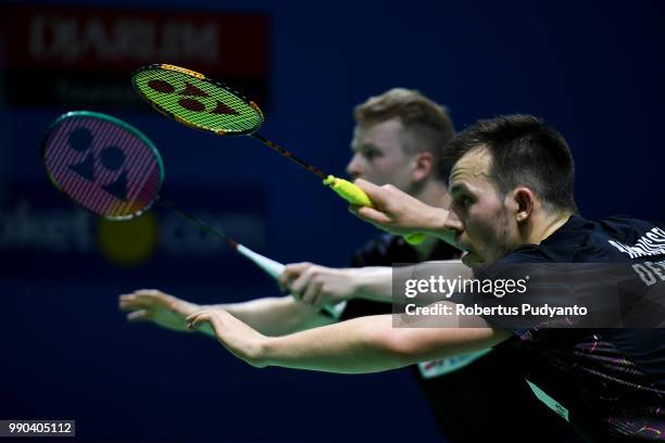 Kim Astrup and Anders Skaarup Rasmussen of Denmark compete against Goh V Shem and Tan Wee Kiong of Malaysia during the Men's Doubles Round 1 match on...