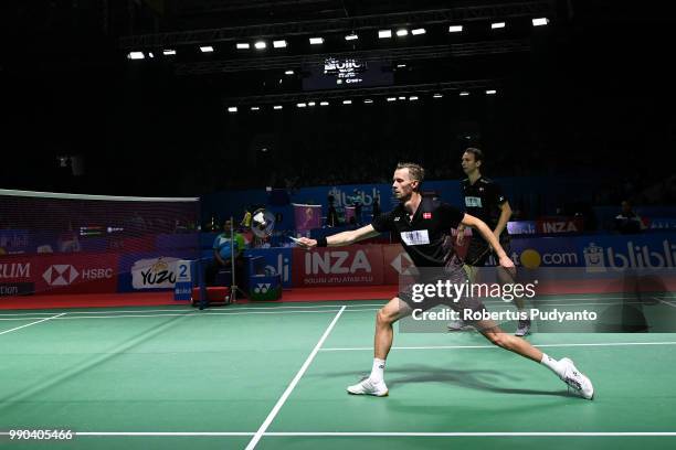 Mathias Boe and Carsten Mogensen of Denmark compete against Liao Min Chun and Su Ching Heng of Chinese Taipei during the Men's Doubles Round 1 match...