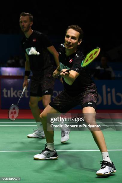 Mathias Boe and Carsten Mogensen of Denmark compete against Liao Min Chun and Su Ching Heng of Chinese Taipei during the Men's Doubles Round 1 match...