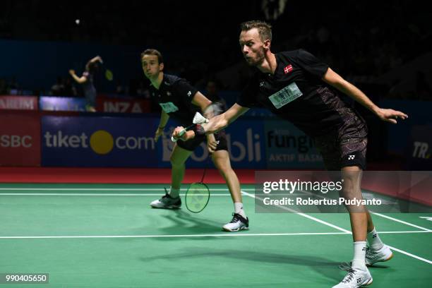 Mathias Boe and Carsten Mogensen of Denmark compete against Liao Min Chun and Su Ching Heng of Chinese Taipei during the Men's Doubles Round 1 match...