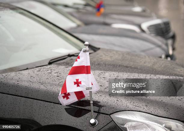 The Georgian flag showing Saint George's cross embellishes a limousine outside the German President Frank-Walter Steinmeier's New Year's reception in...