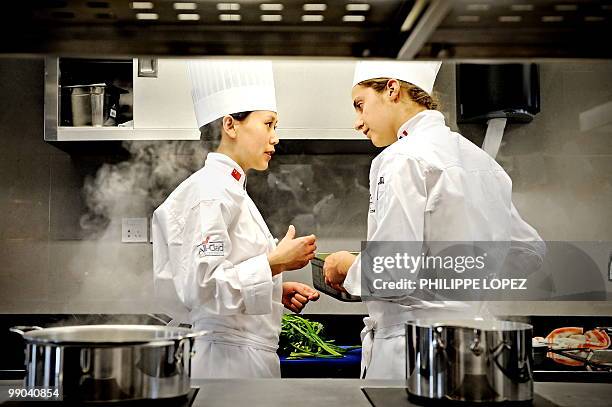 Staff members of the France's Rhone-Alpes restaurant pavilion by Institut Paul Bocuse are seen in the kitchen at the site of the World Expo 2010 in...