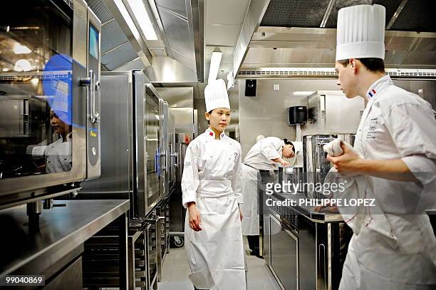 Staff members of the France's Rhone-Alpes restaurant pavilion by Institut Paul Bocuse are seen in the kitchen at the site of the World Expo 2010 in...