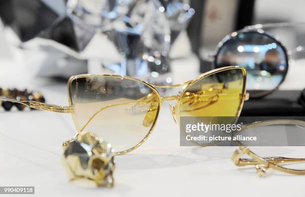Pair of glasses are displayed at the booth of manufacturer Philippe V during the Opti fair in Munich, Germany, 12 January 2018. The specialist fair...