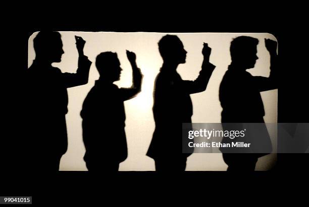 Australian vocal group Human Nature Toby Allen, Michael Tierney, Andrew Tierney and Phil Burton cast shadows on a screen as they perform after...