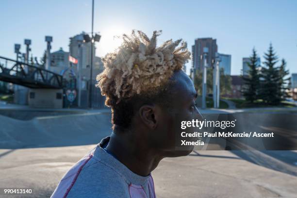 bmx rider enjoys stunt riding in urban park - dyed hair stock pictures, royalty-free photos & images