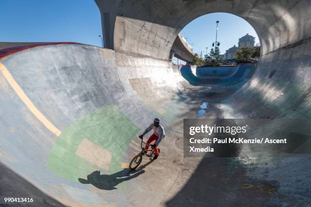 bmx rider enjoys stunt riding in urban park - low section bildbanksfoton och bilder