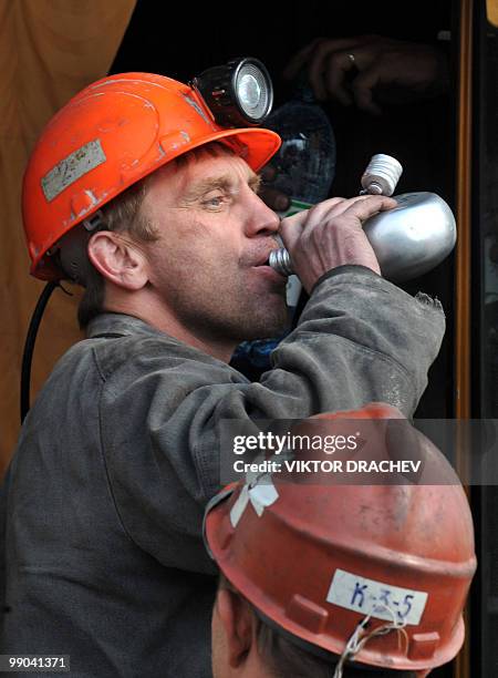 Russian rescuer drinks water as he takes part in the rescue operation at Raspadskaya mine in the town of Mezhdurechensk, Kemerovo region of Western...