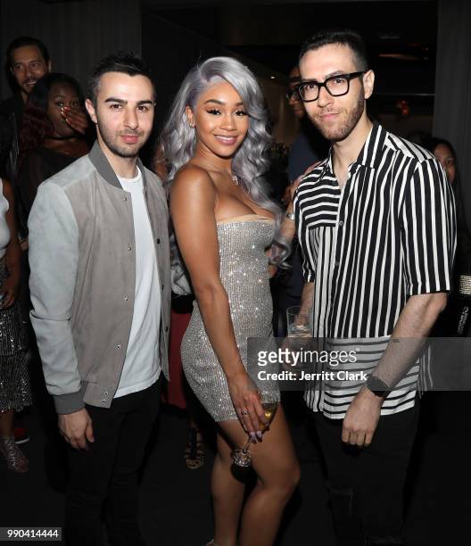Saweetie poses with Cameron Lazerine and Devin Lazerine, Founders of Rap-Up, at Saweetie's Birthday Dinner at Katsuya on July 2, 2018 in Los Angeles,...