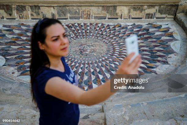 Visitor takes a selfie at the Medusa mosaic in Turkey's southern province of Burdur's ancient city of Kibyra on July 02, 2018. Approximately 2000...