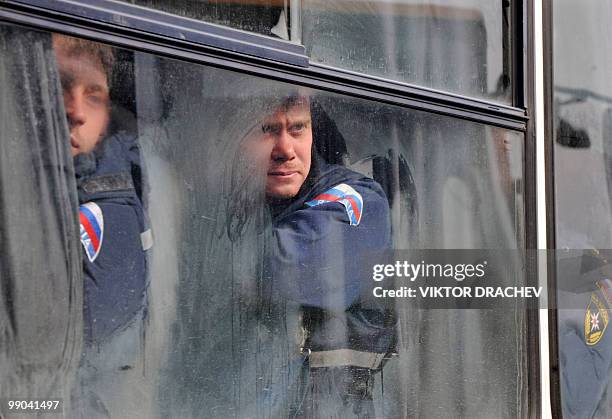 Russian Emergency Ministry servicemen sit inside of a bus as they take part in the rescue operation at Raspadskaya mine in the town of...