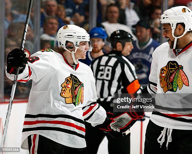 Patrick Kane of the Chicago Blackhawks celebrates his goal with teammate Dustin Byfuglien Game 6 of the Western Conference Semifinals during the 2010...