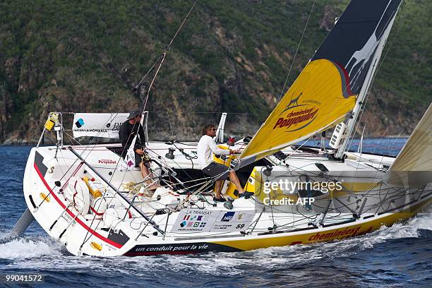 French skippers Bernard Stamm and Gildas Mahe sail on their "Cheminées Poujoulat" monohull upon their arrival in Saint-Barthelemy, French west...