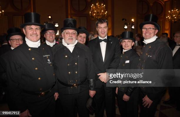 Bavarian Finance Minister and prime candidate for teh state elections, Markus Soeder pictured with Kaminkehrern at a New Year reception at the...