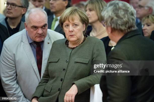 German Chancellor Angela Merkel speaks with the mayor of Zingst, Andreas Kuhn during the New Year's Reception of the state counsil of the district...